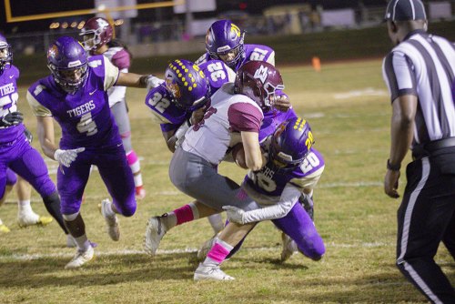 The Tigers' defense bore down on the Pioneers. Here Elijah Jones, 
Elijah Mccalister, David Moore, and Ozzy Hernandez beat down on a Pioneer running back.